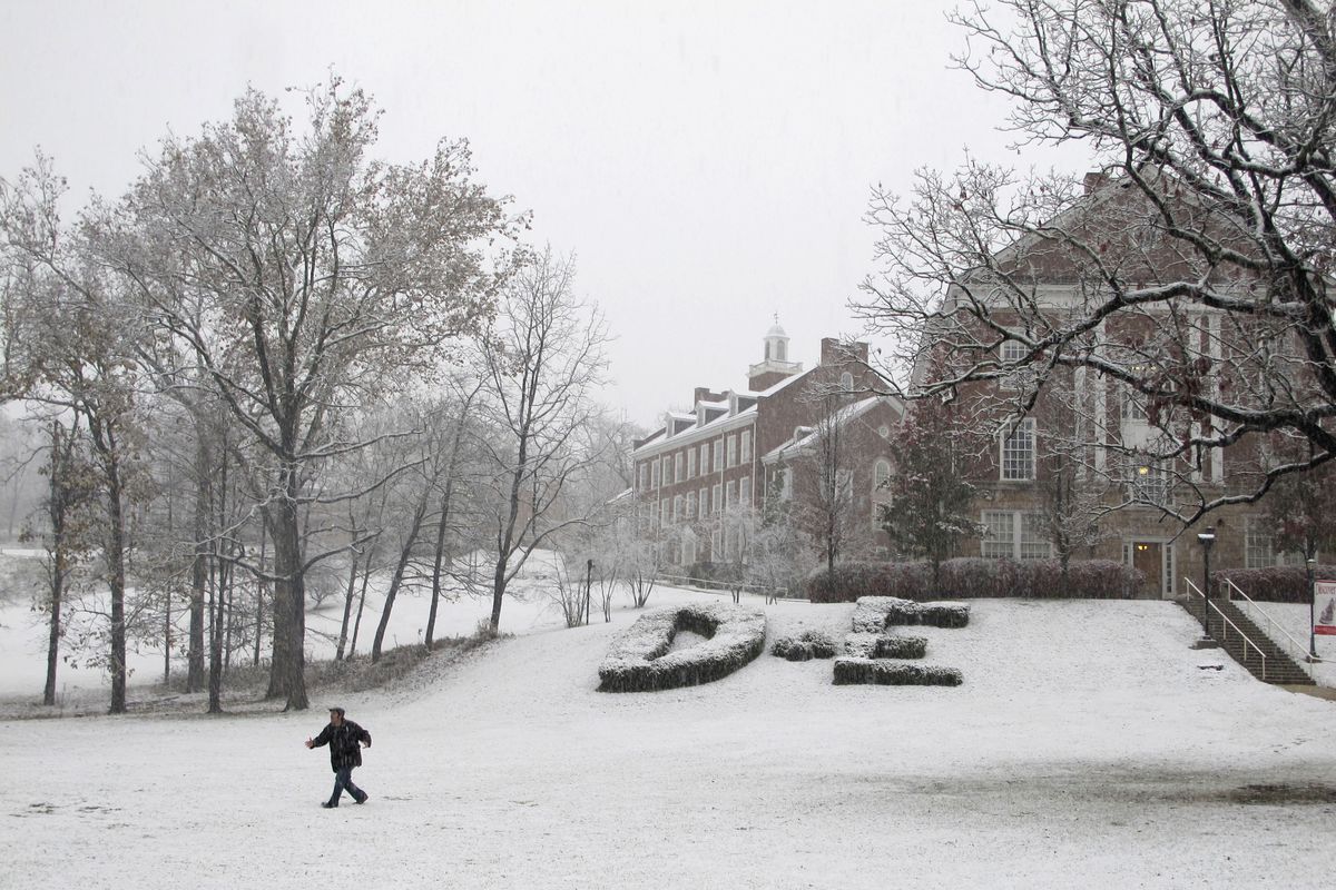 A student walks across the lawn at Davis & Elkins College as the snow started falling hard in Elkins, W. Va., on Monday, Oct. 29, 2012. (Vicki Smith / Associated Press)