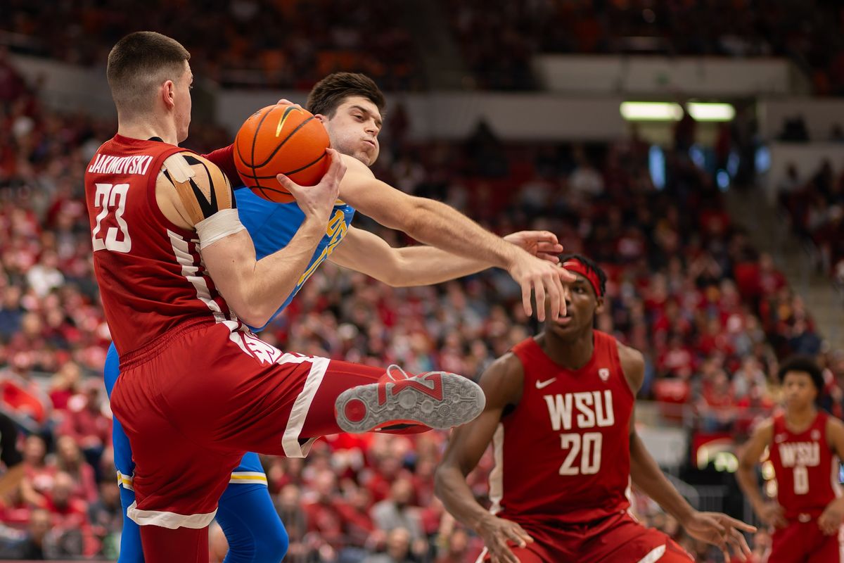 Washington State forward Andrej Jakimovski, left, slips past UCLA guard Lazar Stefanovic to grab a rebound in the first half on Saturday, March 2, 2024, at Beasley Coliseum in Pullman.  (Geoff Crimmins/For The Spokesman-Review)
