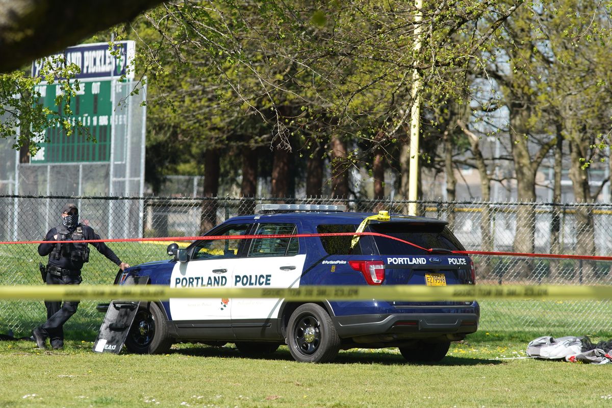 A Portland Police officer stand by following a police involved shooting of a man at Lents Park, Friday, April 16, 2021, in Portland, Ore. Police fatally shot a man in the city park Friday morning after responding to reports of a person with a gun, authorities said.  (Mark Graves/The Oregonian)