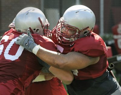 Senior Zack Williams, right, battling Elliott Bosch in practice, has moved from guard to center in one of many changes on the offensive line. (Dan Pelle)