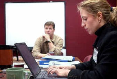 
Nienke Carter, right, takes notes on her laptop while Lewis and Clark English teacher Greg Goeller talks about how teachers at the school help students achieve success Thursday morning. Carter, from the National Center for Educational Accountability, is researching educational practices from Washington's best schools. 
 (Holly Pickett / The Spokesman-Review)