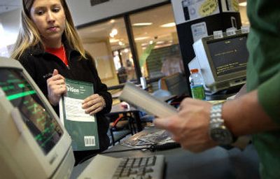 
Eastern Washington University junior Stephanie Fisher finds out what her refund will be for selling her used textbooks at EWU on Wednesday afternoon. 
 (Holly Pickett / The Spokesman-Review)