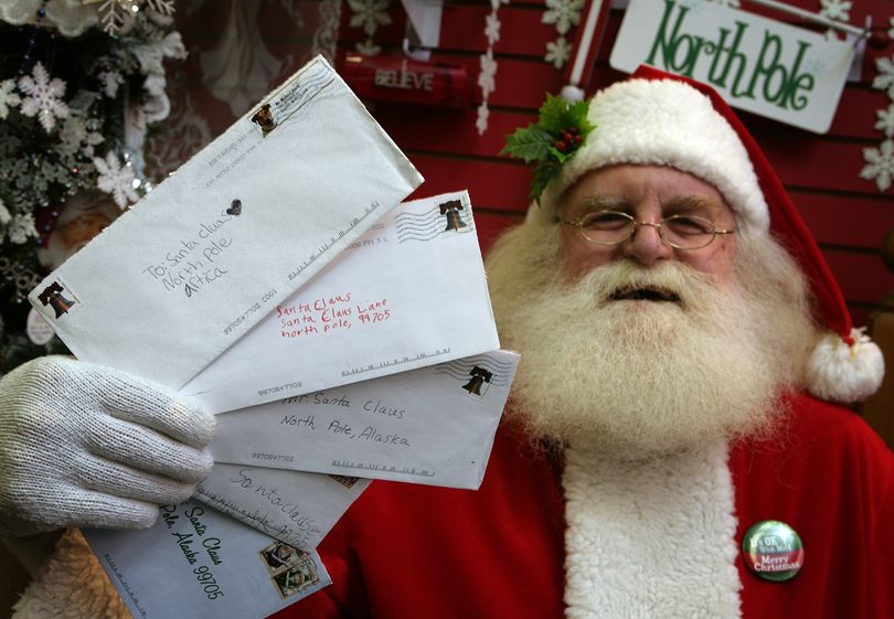 Santa Claus, also known as Patrick Farmer, at Santa Claus House in North Pole, Alaska Wednesday Nov. 18, 2009, holds letters from children sent this year that the U.S. Postal Service says they will no longer deliver. Citing privacy concerns, postal officials say that generically addressed letters to 