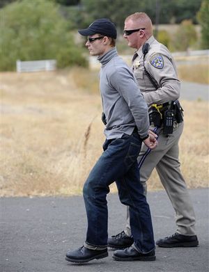 California Highway Patrol Officer Duane Nokes takes David Joseph Pedersen into custody following a traffic stop on Marysville Road and Gettys Court near Yuba City, Calif. on Wednesday, Oct. 5, 2011. Pedersen and his girlfriend Holly Ann Grigsby are wanted for a murder in Washington state and the disappearance of a teenager in Oregon. (AP Photo/Appeal Democrat, David Bitton) ((AP Photo/Appeal Democrat, David Bitton))