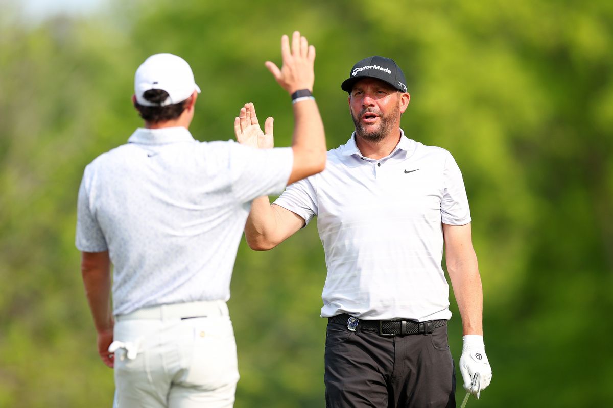 Michael Block, right, a PGA of America club professional, high-fives Rory McIlroy after Block’s hole-in-one on the 15th tee during the final round of the PGA Championship at Oak Hill Country Club last Sunday in Rochester, New York.  (Tribune News Service)