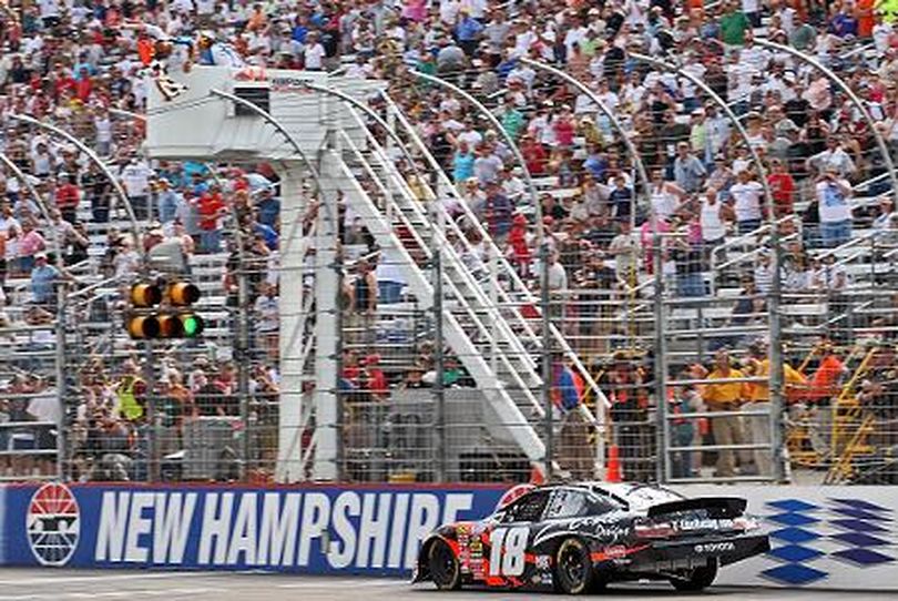 Kyle Busch, driver of the No. 18 Z-Line Designs Toyota, crosses the finish line after winning the Camping World RV Sales 200 NASCAR Nationwide Series race Saturday at New Hampshire Motor Speedway. (Photo Credit: Drew Hallowell/Getty Images for NASCAR)  (Drew Hallowell / The Spokesman-Review)