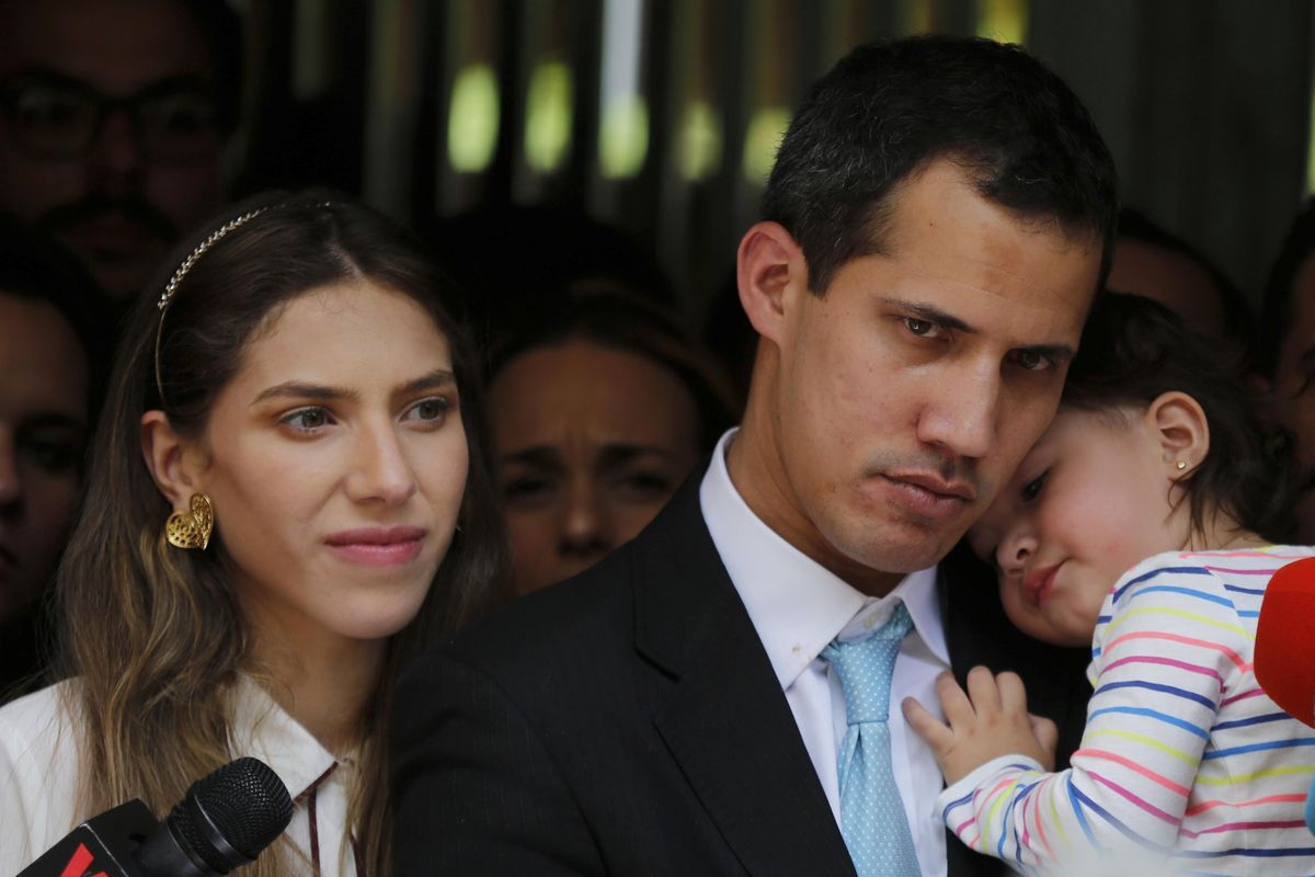 Opposition National Assembly President Juan Guaido, accompanied by his wife Fabiana Rosales and his 20-month-old daughter Miranda, listens to a reporter’s question during a news conference outside their apartment, in Caracas, Venezuela, Thursday, Jan. 31, 2019. Guaido said security forces showed up at their home in an attempt to intimidate him. “The dictatorship thinks it can intimidate us,” Guaido said. (Fernando Llano / Associated Press)