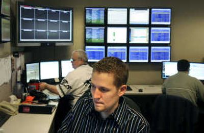 
Inland Northwest Health Services  help desk coordinators Joe Gellatly, center, Kurt Leppert, left, and Shawn Bleisner man the network monitoring center in downtown Spokane on Thursday. The center supports more than 40 hospitals and 450 physician offices and clinics throughout the United States. 
 (Dan Pelle / The Spokesman-Review)