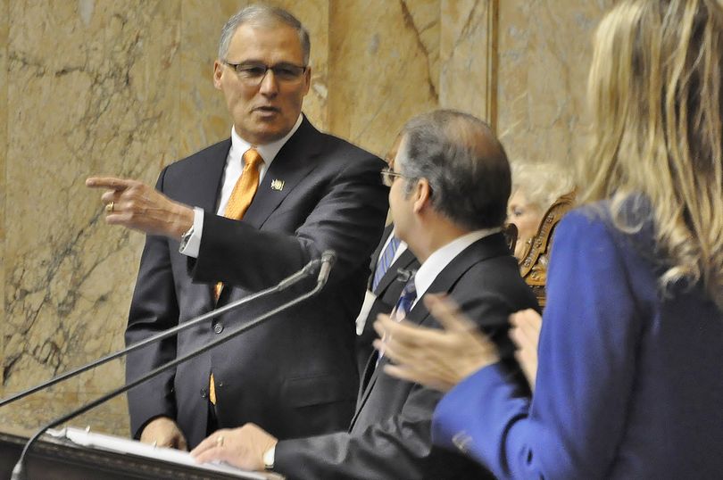 OLYMPIA -- Gov. Jay Inslee (left) is greeted by outgoing Lt. Gov. Brad Owen and Rep. Tina Orwall as he arrives at a special session of the Legislature for his inauguration and speech on 1/11/2017.