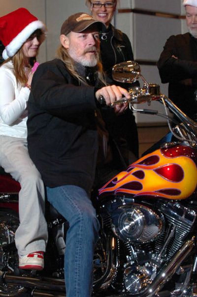 
Steve Groene talks to the media while sitting astride his new motorcycle, a custom chopper presented to him Friday at the Coeur d'Alene Resort during the taping of a segment of Geraldo Rivera's nationally syndicated show.  On the back of the bike is his daughter, Shasta. 
 (Jesse Tinsley / The Spokesman-Review)