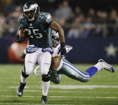 Eagles running back LeSean McCoy, tackled by Devone Holloman, had 131 yards rushing and a touchdown catch. (Associated Press)