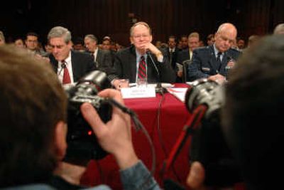 
National Intelligence Director Mike McConnell,  flanked by FBI Director Robert Mueller, left, and Gen.  Michael Hayden, CIA director, waits to testify Tuesday before the Senate Intelligence Committee. Associated Press
 (Associated Press / The Spokesman-Review)
