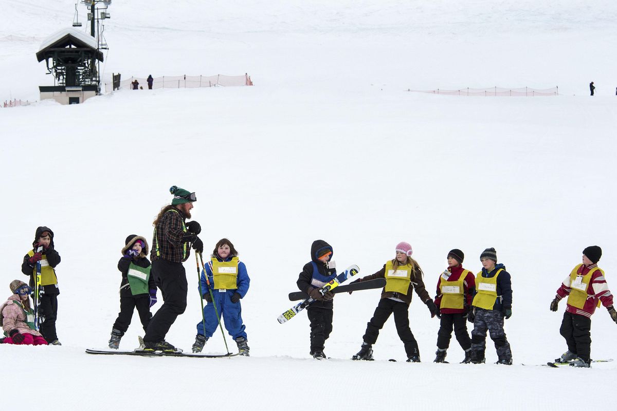 Andy Fuzak, Mt. Spokane ski instructor, works with children from Loon Lake Elementary School on Friday.  About 50 students are participating in the school’s winter ski program. (Dan Pelle / The Spokesman-Review)
