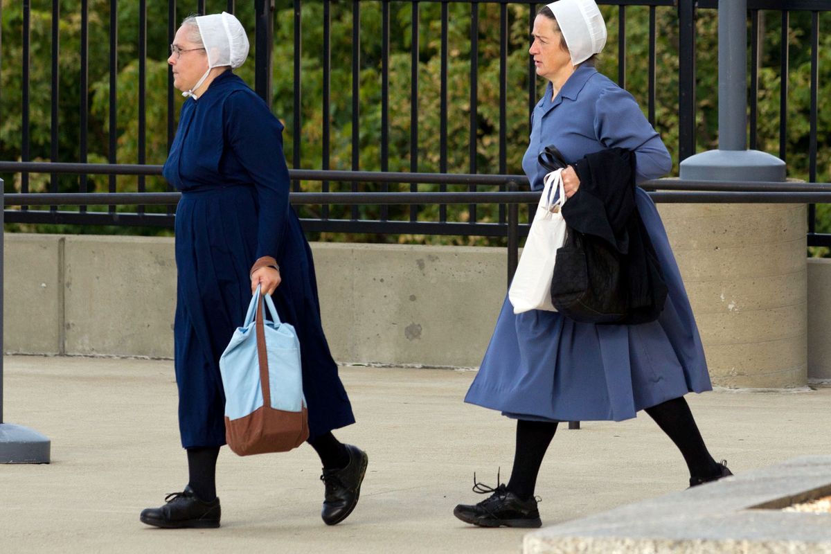 Two Amish women walk to the U.S. Federal Courthouse in Cleveland on Thursday, Sept. 20, 2012.  The jury will begin their fifth day of deliberations in the trial of 16 Amish people accused of hate crimes in hair- and beard-cutting attacks against fellow Amish in Ohio. (Scott Galvin / Fr170532 Ap)