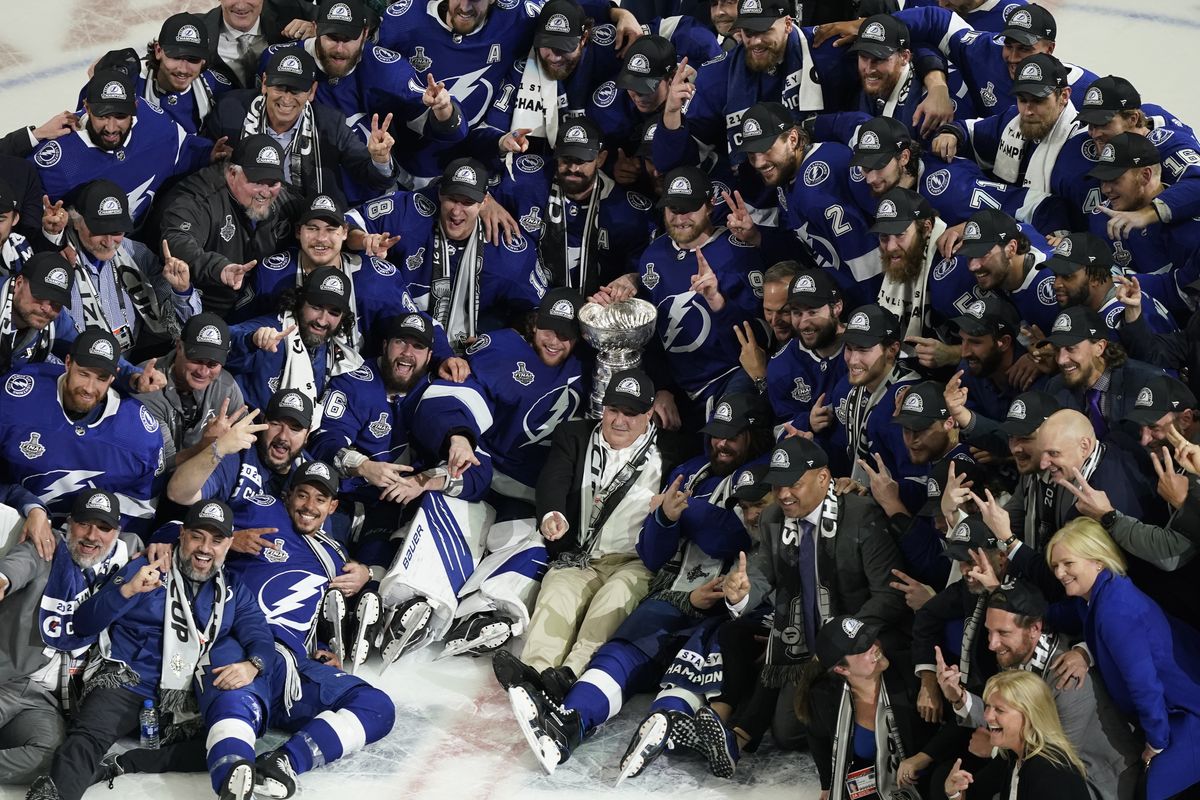 The Tampa Bay Lightning pose with the Stanley Cup Wednesday in Tampa, Fla., after defeating the Montreal Canadiens in five games.  (Gerry Broome)