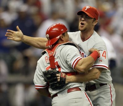 Phillies closer Brad Lidge, right, and catcher Carlos Ruiz celebrate eliminating the Brewers with a Game 4 win. (Associated Press / The Spokesman-Review)