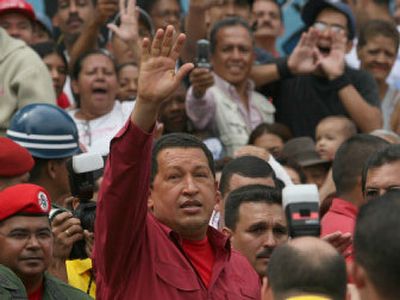 
Venezuelan President Hugo Chavez waves to supporters Sunday after voting  in Caracas. 
 (Associated Press / The Spokesman-Review)