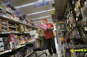 Clyde Decker wears his bright red Christmas shirt that reads “Hillyard Santa” on the front and “For The Kids” on the back, Friday as he shops for toys at Walgreens. “I love this store because they have such good deals,” said Decker.   (CHRISTOPHER ANDERSON / The Spokesman-Review)