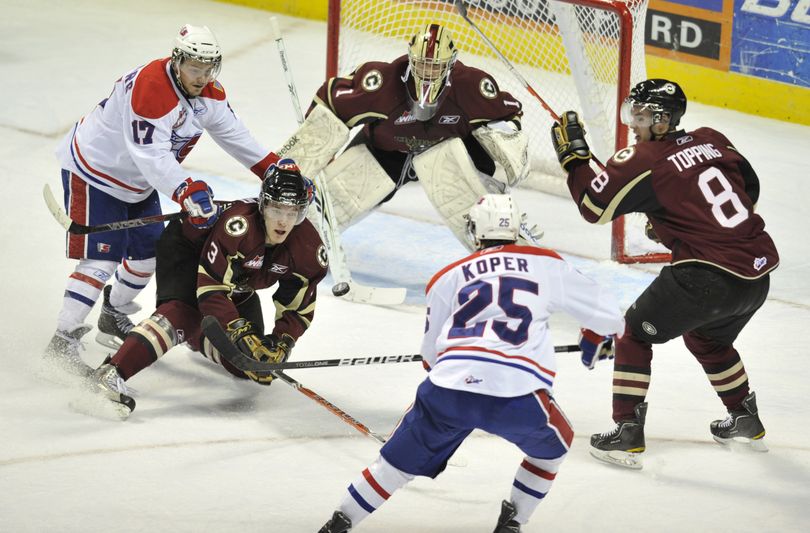 Spokane Chiefs'  Levko Koper makes an unsuccessful shot on goal against on the Chilliwack's goaltender Lucas Gore in the first period of their WHL first-round playoff  game, Thursday, March 31, 2011, in the Spokane Arena.  (Colin Mulvany / The Spokesman-Review)