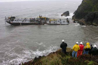 
In a photo supplied by the U.S. Coast Guard, members of the incident command observe the salvage of the grounded barge Millicoma near Ilwaco, Wash., on Wednesday. The barge was freed, and its 3,000 to 5,000 gallons of diesel will be offloaded. 
 (Associated Press / The Spokesman-Review)