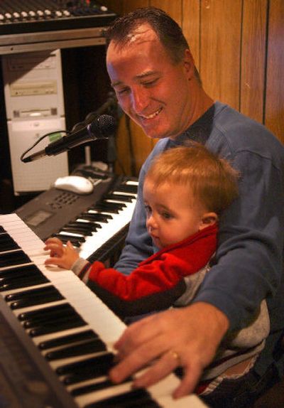
Local musician and songwriter Jimmy Finn hangs out in his studio with his 16-month-old son Justin. Finn has been a member of the group Rhythm Method for a year.
 (Liz Kishimoto / The Spokesman-Review)