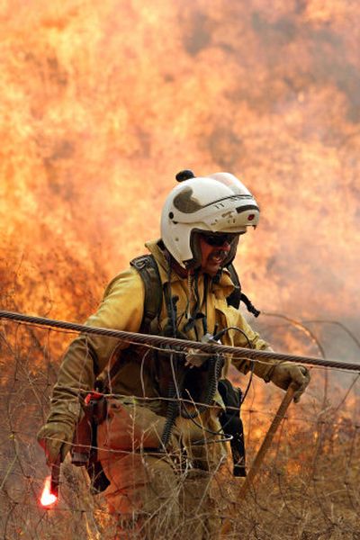 
A California Department of Forestry firefighter sets a backfire to combat a blaze in Simi Valley, Calif., Friday. 
 (Associated Press / The Spokesman-Review)