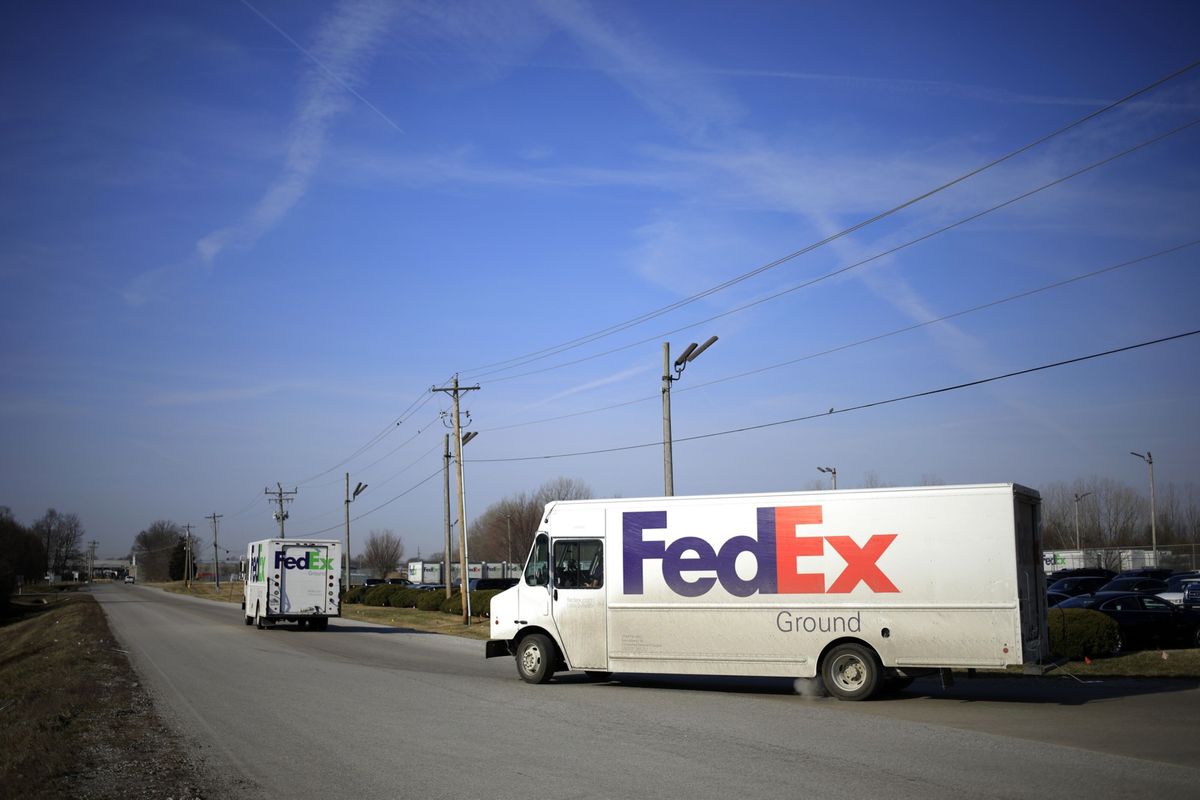 FedEx Corp. Ground trucks drives through Jeffersonville, Indiana, on March 8, 2021.   (Luke Sharrett/Bloomberg)