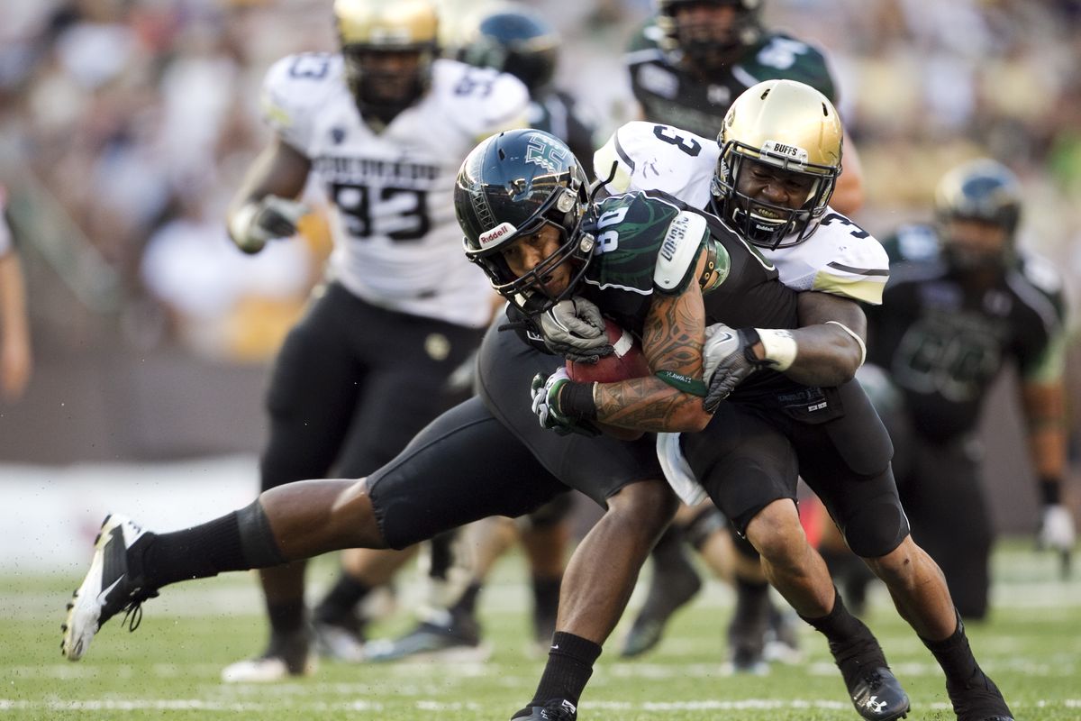 Middle linebacker Douglas Rippy, tackling Hawaii’s Jeremiah Ostrowski, gives Colorado a big push up the middle. (Associated Press)