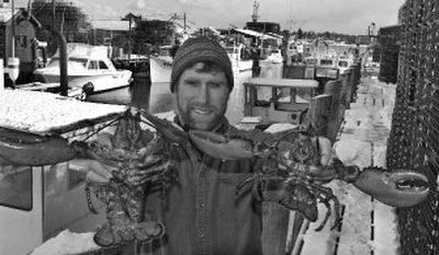 
Lobsterman Tom Martin, of Portland, Maine, holds lobsters he recently trapped as he stands next to his boat along the wharf in Portland earlier this week.. Martin says he is offended at a decision last June by Whole Foods Market banishing lobsters from the company's stores. Now, Martin says he doesn't like that the natural foods store has selected a lobster supplier out of New Hampshire, rather than Maine. The Portland store will open next week with live lobsters for sale. 
 (Associated Press / The Spokesman-Review)
