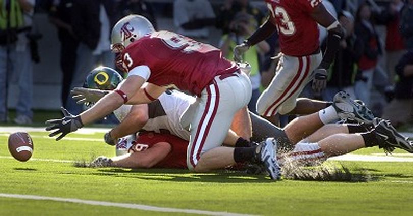 WSU defensive players #93  Kevin Kooyman ( top ) and Steve Dildine ( bottom of pile ) dive after a fumble on the goalline in the first half of their game against Oregon Saturday October 21, 2006 at Martin Stadium in Pullman.  CHRISTOPHER ANDERSON The Spokesman-Review (Christopher Anderson / The Spokesman-Review)