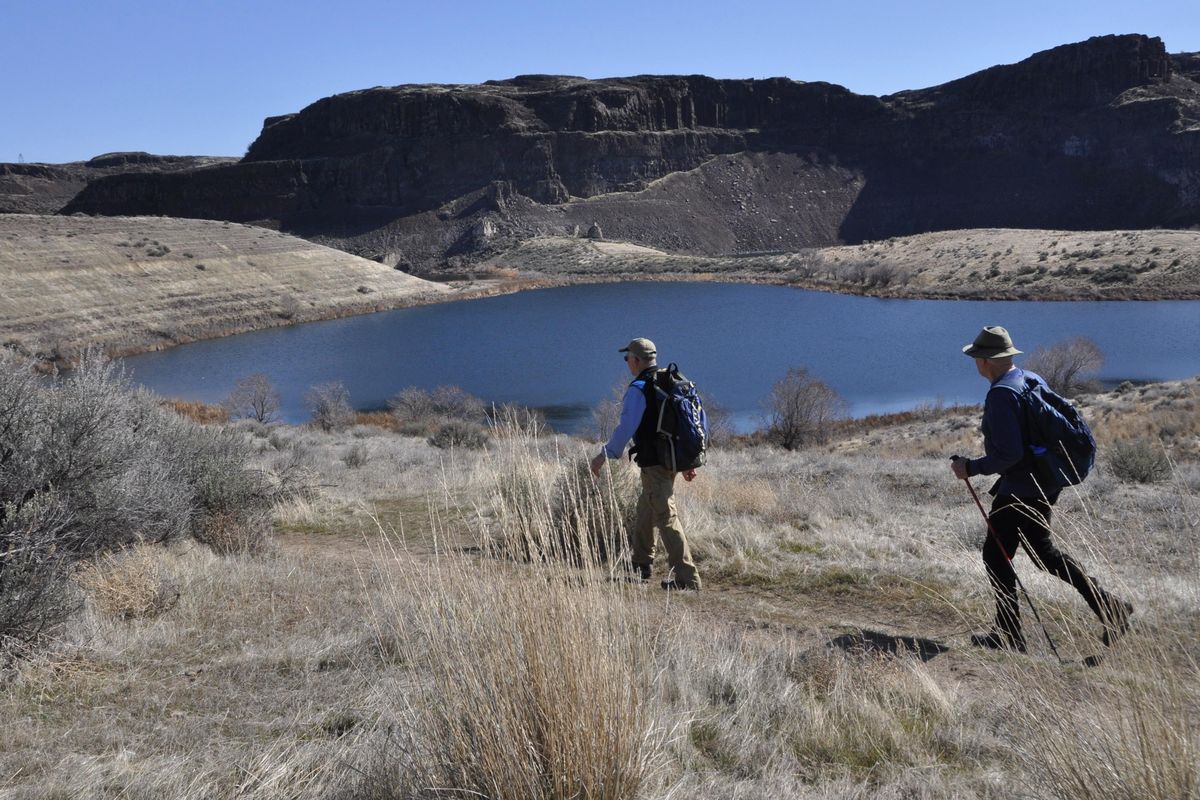 Hikers trek toward the three-tier waterfall that feeds the Ancient Lakes in the Columbia Basin near Quincy, Washington. (Rich Landers / The Spokesman-Review)