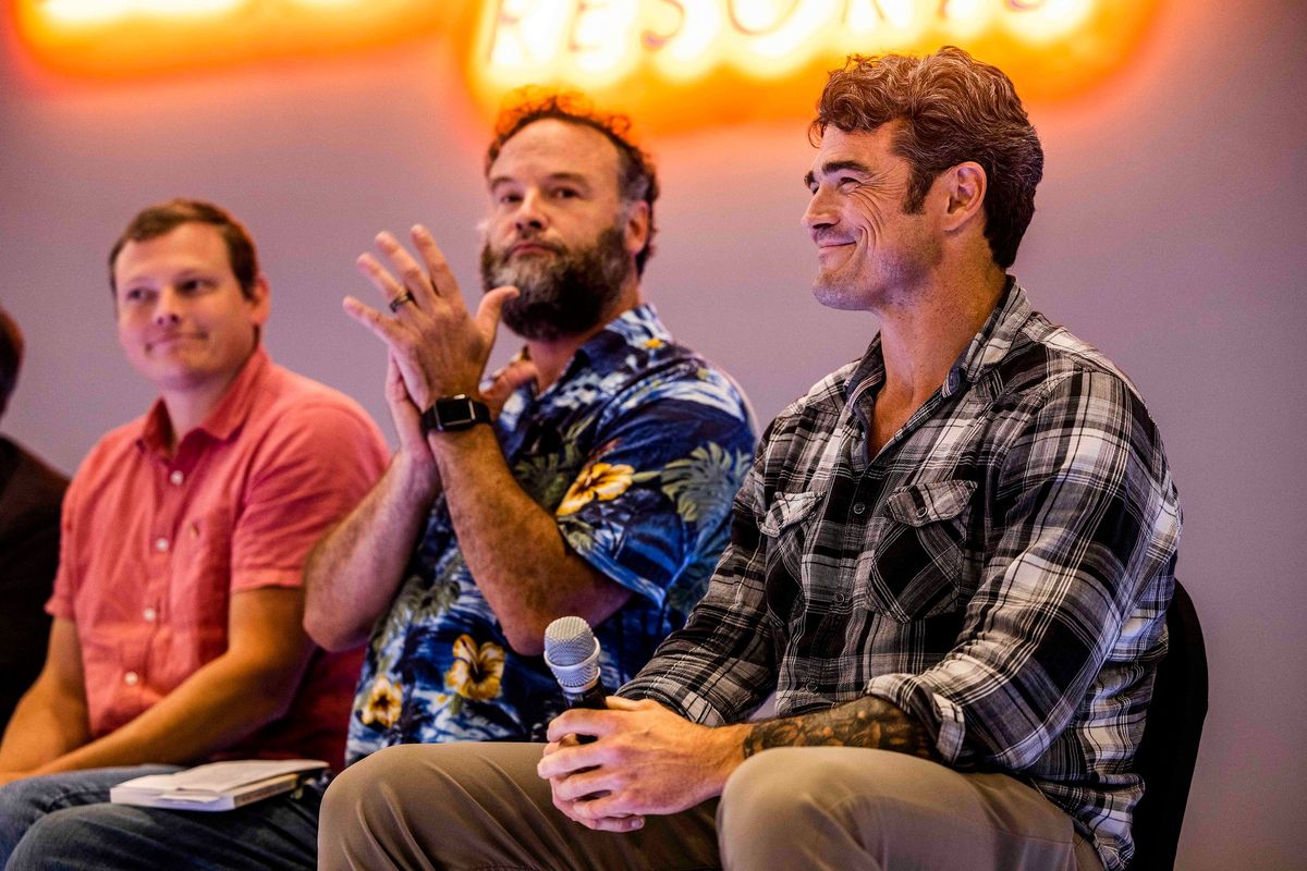 Joe Kent, right, smiles as he speaks Sept. 8 on a panel with others at the RV Inn Style Resort Convention Center in Vancouver, Wash.  (Daniel Kim/Seattle Times)