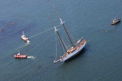 
Tugboats tie on to the 95-year-old schooner Adventuress after it ran aground Monday in Wasp Passage in the San Juan Islands while on a school trip.  No injuries were reported. Associated Press
 (Associated Press / The Spokesman-Review)