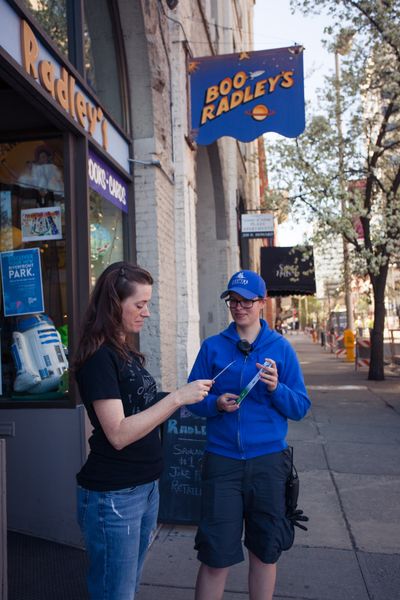 Christina Huggins, right, Downtown Ambassador, shows a 