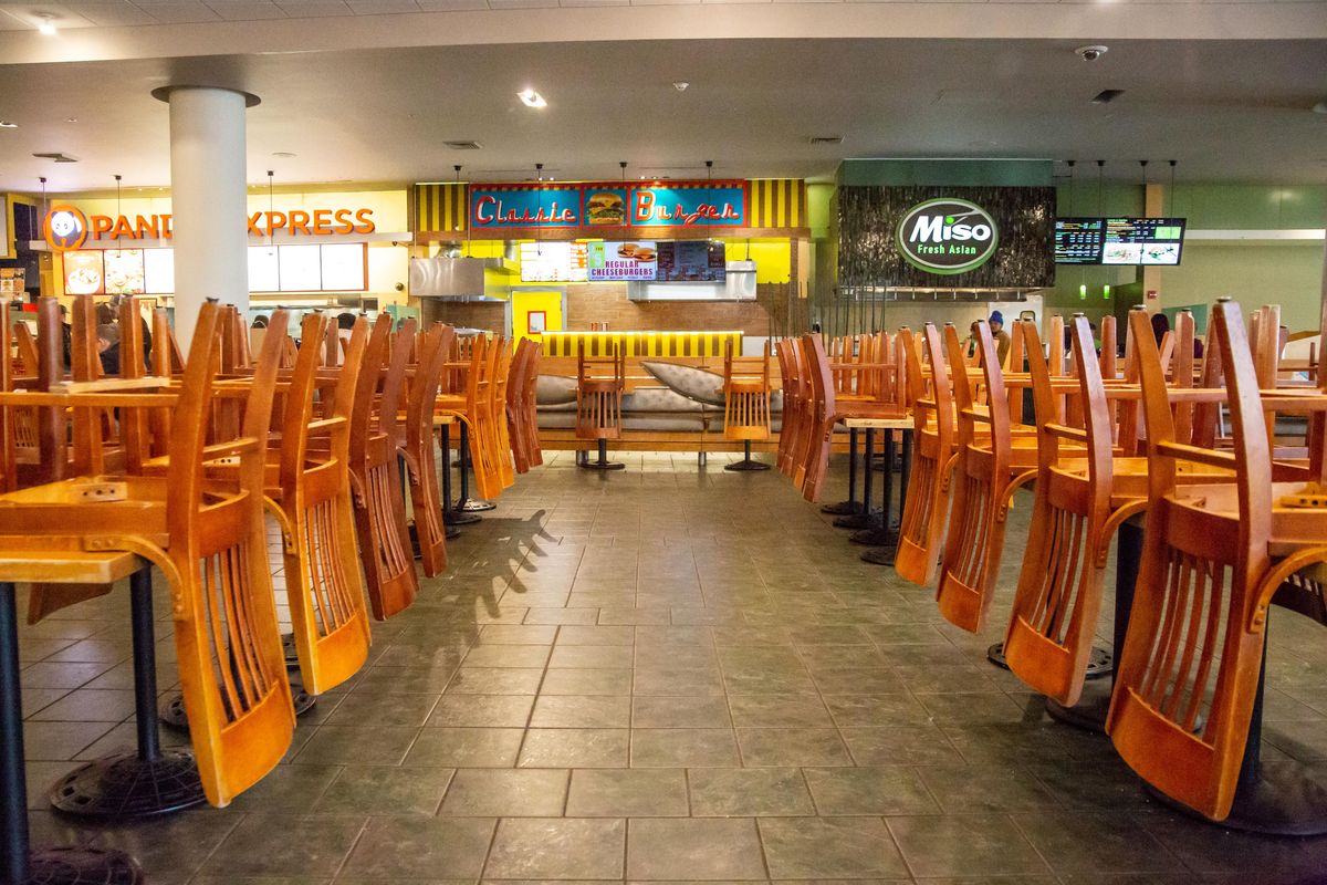 Chairs are stacked on tables in Riverpark Square