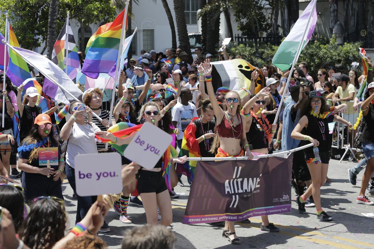 FILE - Participants with the Alliance for GLBTQ Youth march at the annual Miami Beach Gay Pride Parade, Sunday, April 9, 2017, in Miami Beach, Fla. Republican-backed legislation in Florida that could severely limit discussion of gay and lesbian issues in public schools is being widely condemned as dangerous and discriminatory, with one gay Democratic lawmaker saying it’s an attempt to silence LGBTQ students, families and history.  (Lynne Sladky)