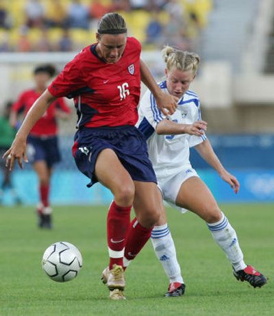 
USA's Abby Wambach, playing against Greece during the 2004 Olympics, is so strong and sturdy it's hard to believe she was once the puny one in her family. 