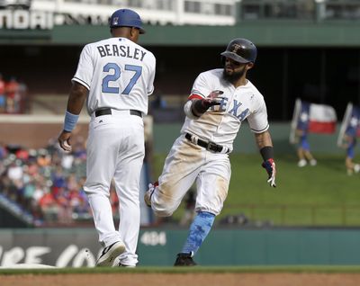 Texas Rangers third base coach Tony Beasley (27) congratulates Rougned Odor, right, on his solo home run that came off a pitch from Seattle Mariners relief pitcher Dan Altavilla in the sixth inning of Rangers 10-4 win on June 17, 2017, in Arlington, Texas. (Tony Gutierrez / Associated Press)
