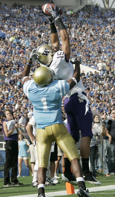 Washington’s Jermaine Kearse catches a touchdown pass over UCLA’s Alterraun Verner.  (Associated Press)