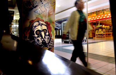 A shopper walks past Graffiti Skate Shop in Coeur d’Alene’s Silver Lake Mall. Mall managers are struggling to keep businesses afloat during the recession.  (Kathy Plonka / The Spokesman-Review)