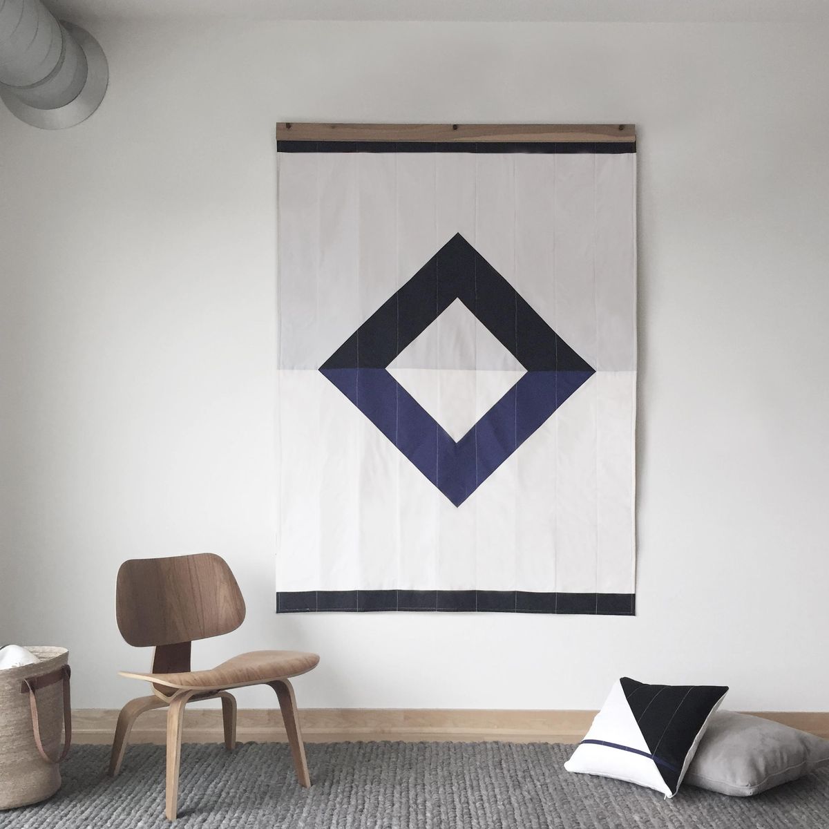 This image released by Louise Gray shows a mounted quilt which was handmade by a team of local quilt makers by Minneapolis-based Louise Gray. In 2016, designers and retailers look to give homespun décor a modern twist. (Associated Press)