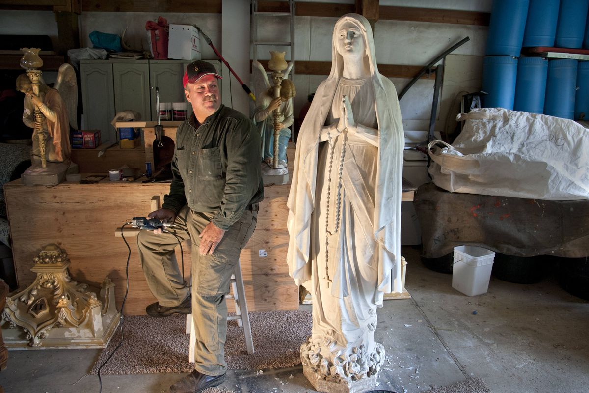 Paul Lestage, of Rathdrum, has been repairing the marble statue of the Virgin Mary in his workshop. He has reattached the head, which was stolen from Mount St. Michael in 2009 and was recently found in a Spokane rental home. He’s also repairing bullet holes and chips. (Dan Pelle)