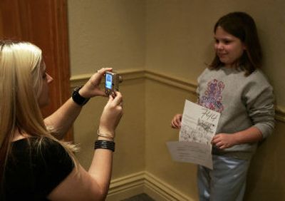 
Casting production assistant Nicole LaBranche photographs Katherine Dorman, 10, of New Orleans during a casting call in Metairie, La., on Saturday for a new Jerry Bruckheimer-produced thriller. 
 (Associated Press / The Spokesman-Review)