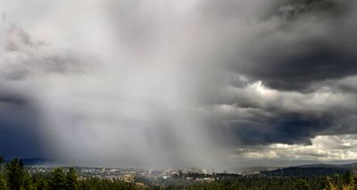 A fast-moving thunderstorm dumps rain and hail on Spokane on Thursday. This photo was taken looking east from the Palisades Park area atop Sunset Hill.  (CHRISTOPHER ANDERSON / The Spokesman-Review)