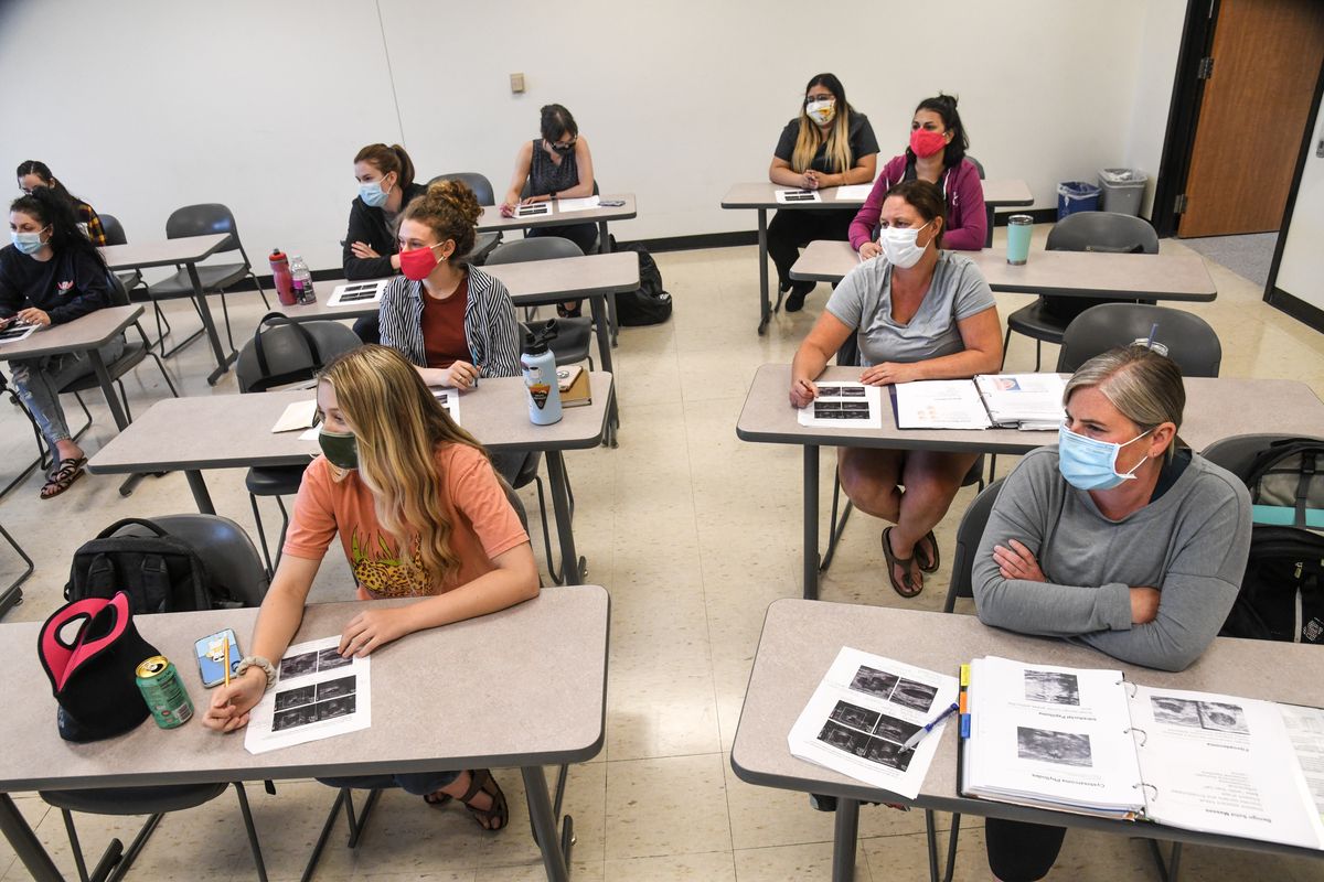 Spokane Community College Health Science students learn about ultrasound as they sit masked and one person to a desk on July 23, 2020.  (DAN PELLE/THE SPOKESMAN-REVIEW)