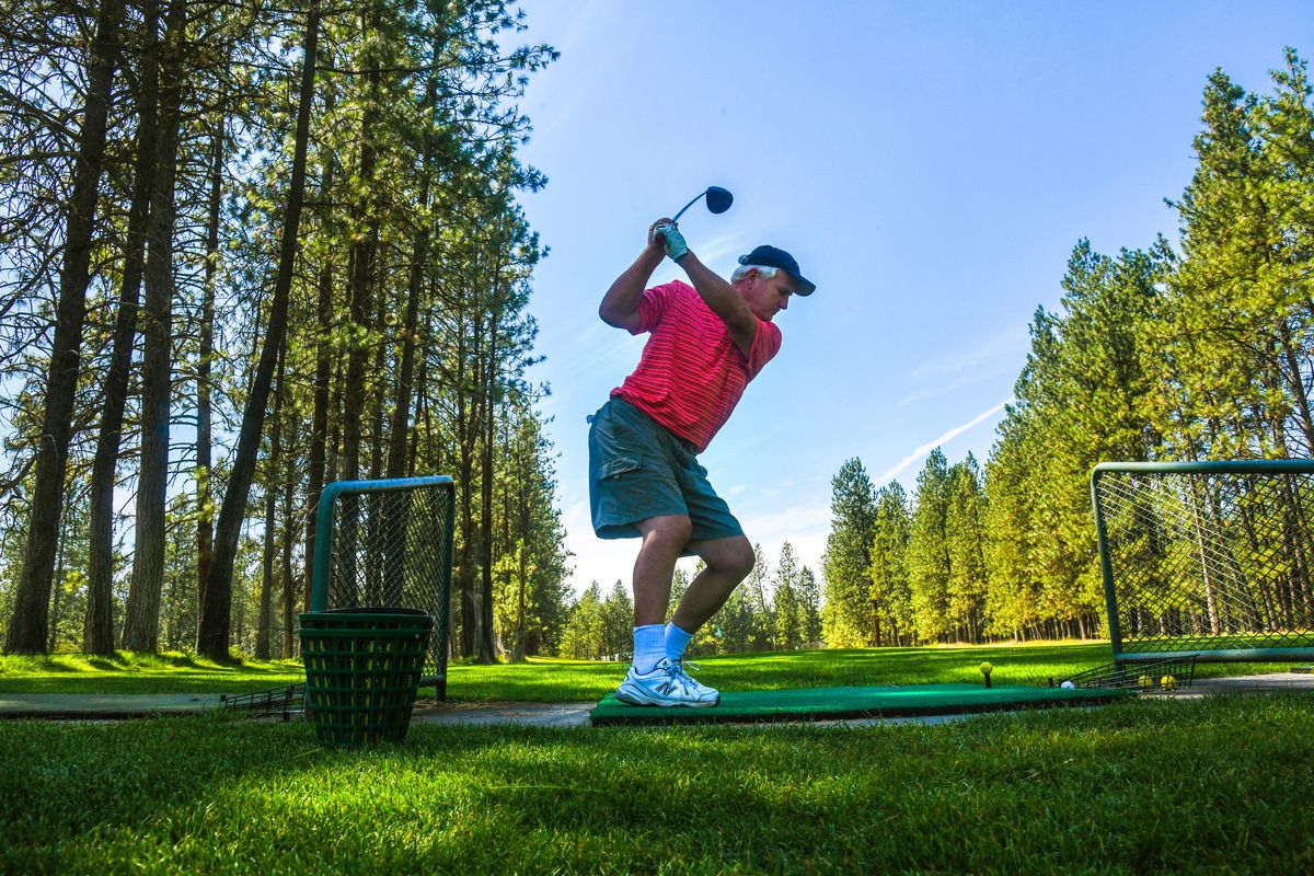 Dan Olson hits some balls on the driving range before playing nine holes, Wednesday afternoon, August 1, 2018, at Sun Dance Golf Course. A local developer applied for permits in April to split the former golf course’s 88 acres into 475 lots for single-family homes. In its application, Sun Dance Meadows LLC said construction would take place over about five years and bring in at least 1,000 new residents. (Dan Pelle / The Spokesman-Review)