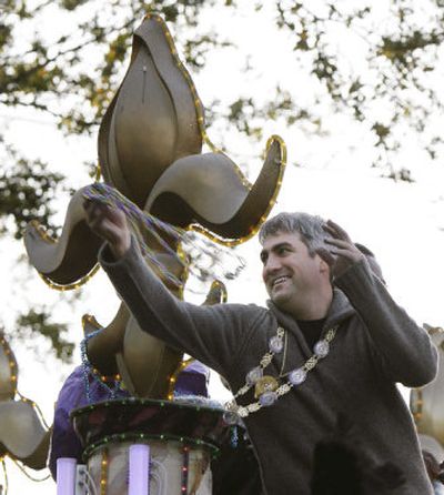 
Taylor Hicks throws beads as he rides as Grand Marshal in the Krewe of Endymion's Mardi Gras parade through the Uptown area of New Orleans on Saturday.
 (Associated Press / The Spokesman-Review)