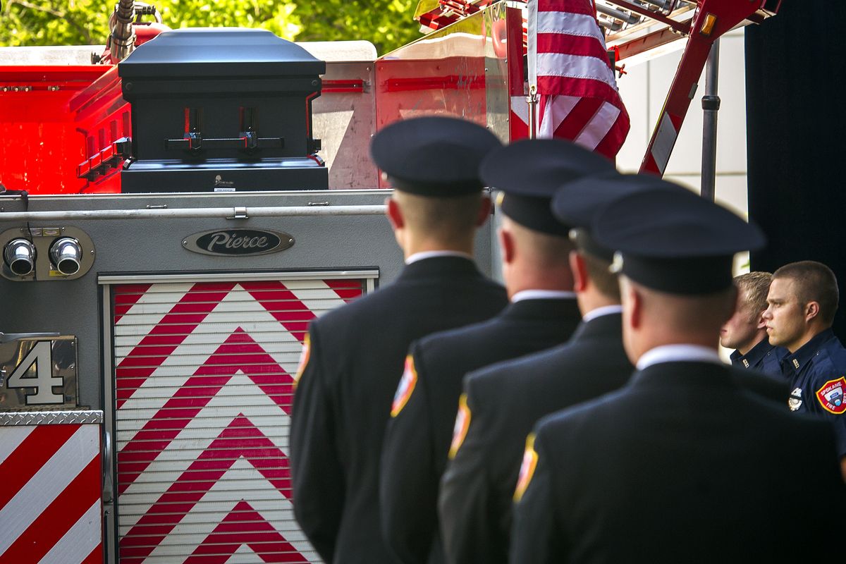 Before a public memorial at the Spokane Convention Center, a Spokane Fire Department honor guard prepares to remove the casket of firefighter John Knighten from a Station 4 fire truck Monday. Knighten, 45, died June 30 after a three-year battle with cancer. (Colin Mulvany)