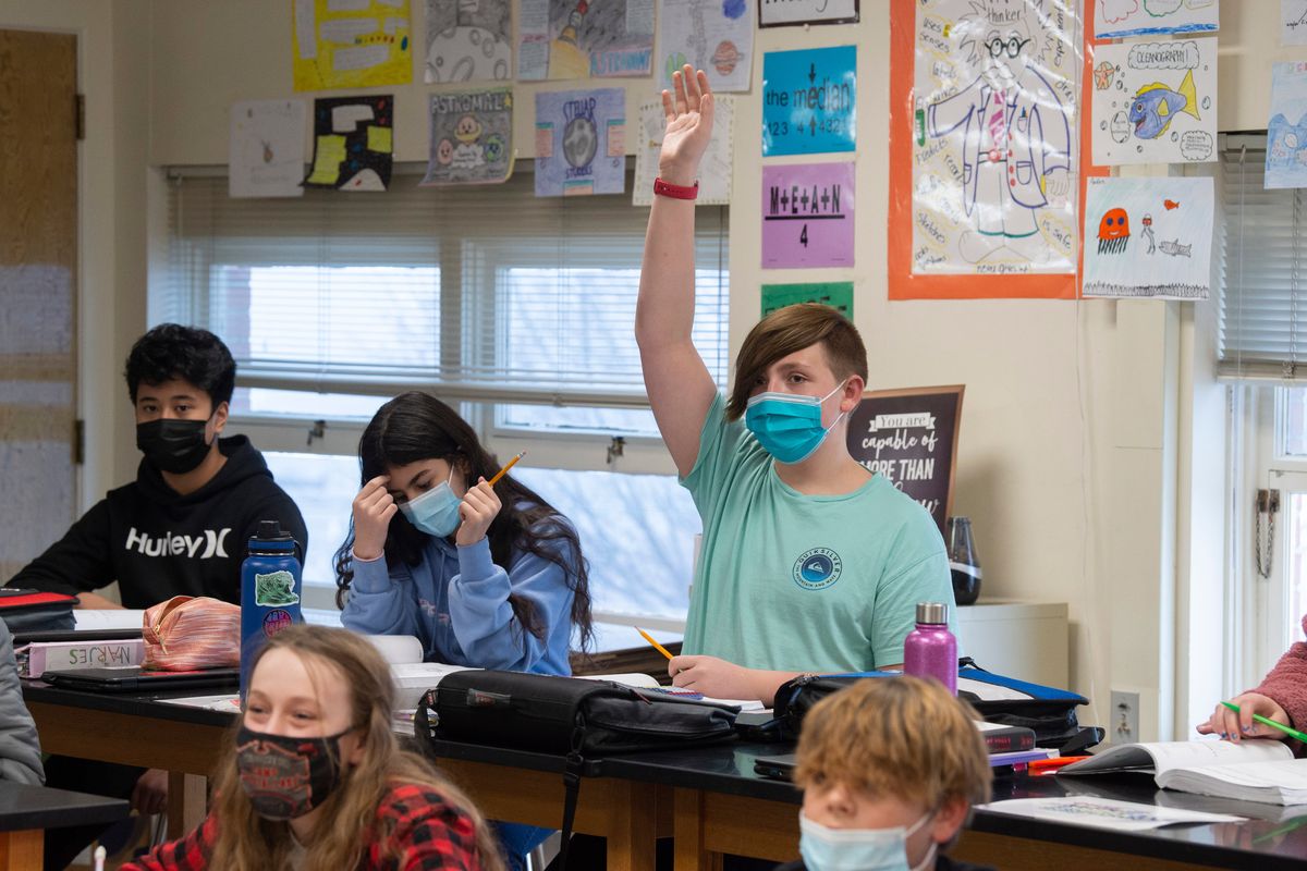 Sixth-grader Brody Baker raises his hand during a math lesson Thursday, Jan. 13, 2022 in his classroom at Adams Elementary in Spokane, Washington. Spokane Schools administrators are struggling with planning problems, which include short staffing and many absent children because of the COVID-19 omicron variant surge.  (Jesse Tinsley/The Spokesman-Review)