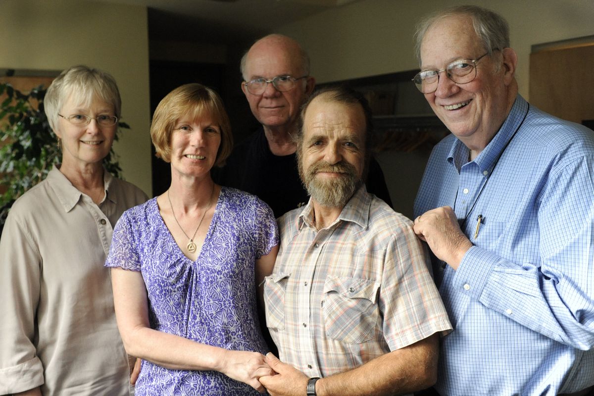 Angie and Bobby Olson, center, stand with their “allies” in their “circle” – from left, Mary Beth Jorgensen, Dale Lloyd and Bob Runkle – after a meeting last month. (Jesse Tinsley / The Spokesman-Review)